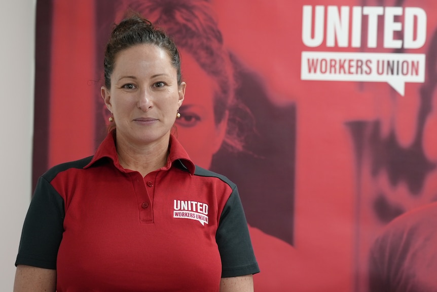 Toni Blacke wears a red United Workers Union shirt