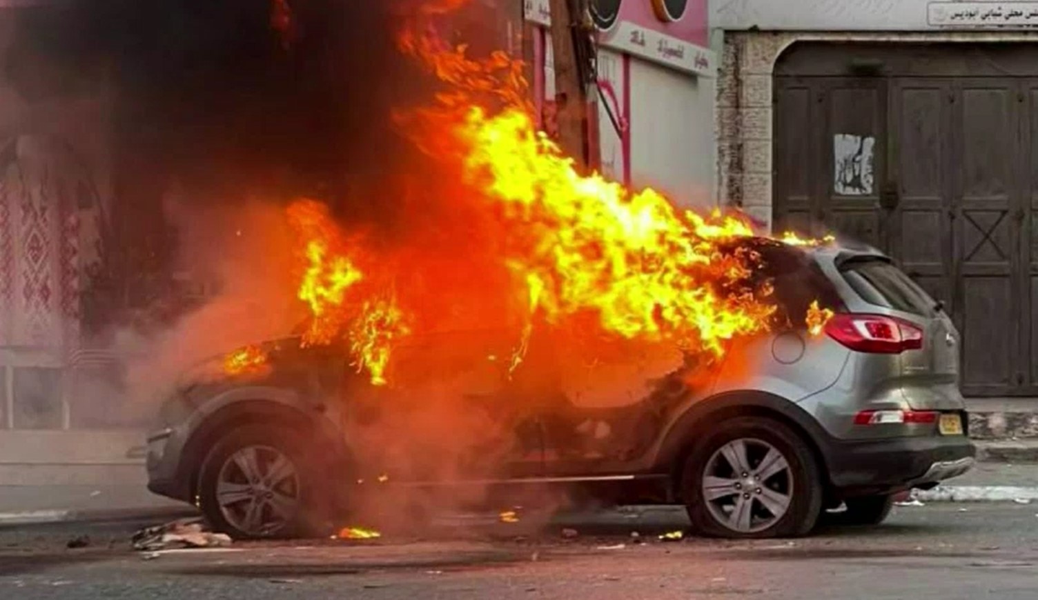 A car burns in a street