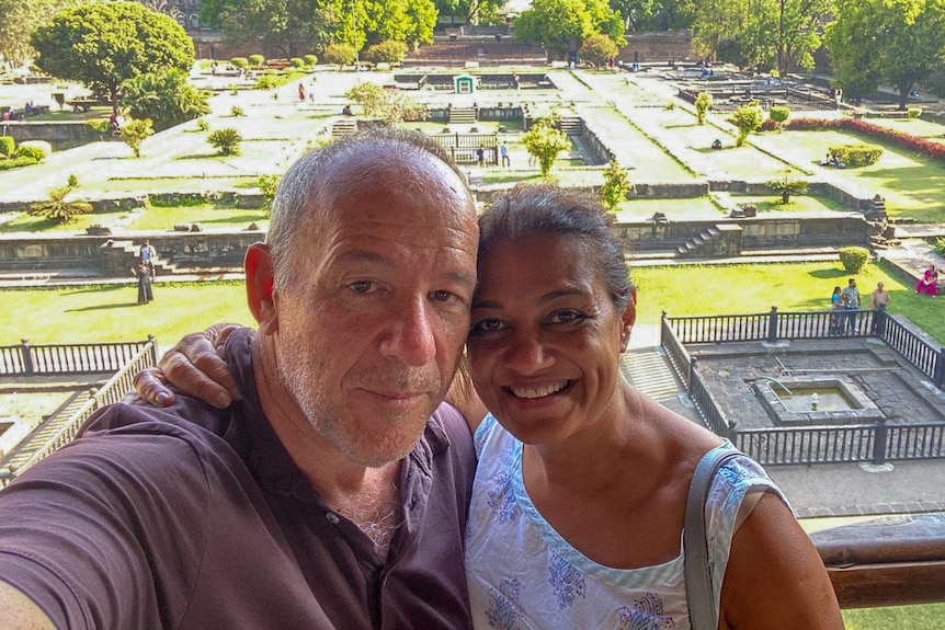 Brad Humphries and his wife Kunti Ranade embrace at a temple in India