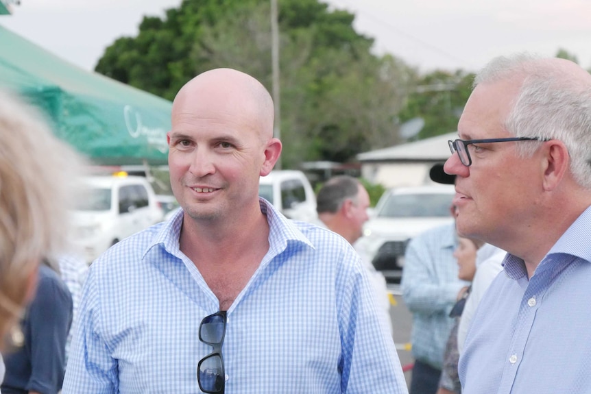 Two men stand next to teach other talking, one is the Prime Minister.