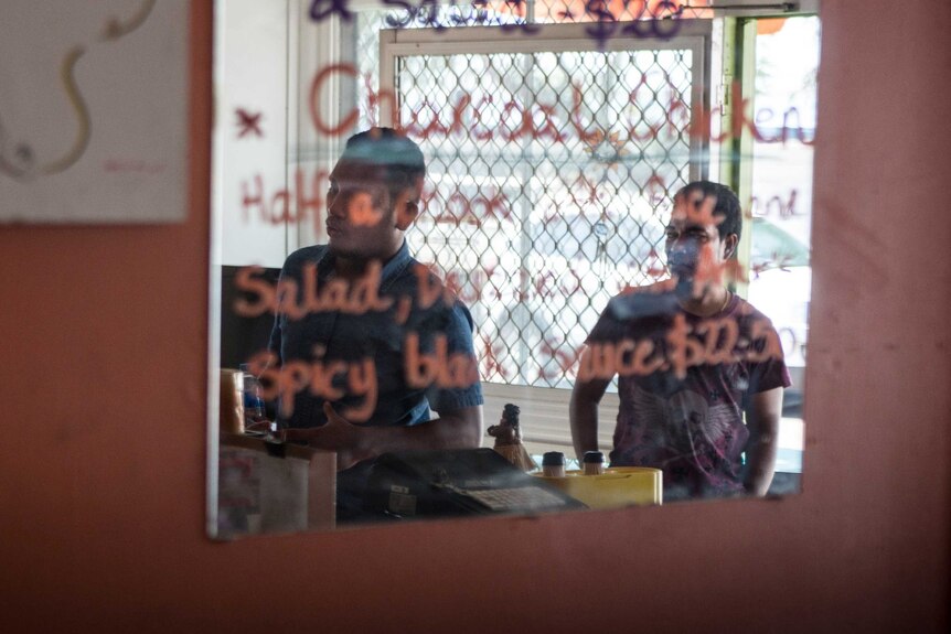 Customers reflected in a mirror at Amye Un's restaurant.