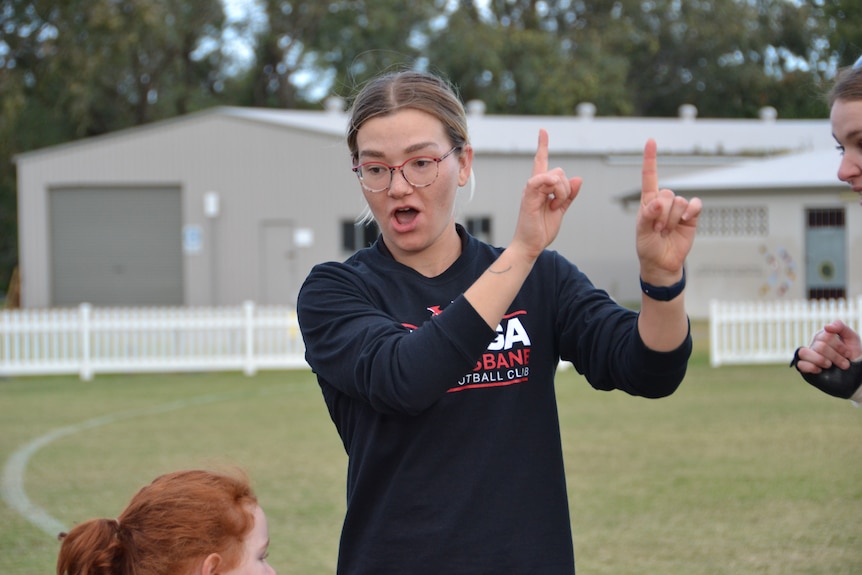 Jamie Howell teaching Auslan Aussie rules at Yeronga South Brisbane Devils AFL club