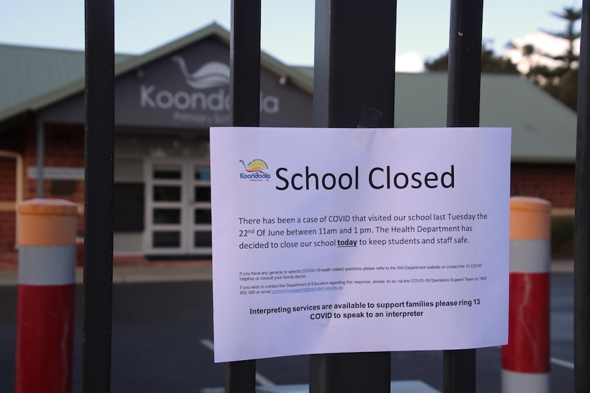 A 'School Closed' sign attached to a fence outside Koondoola Primary School.