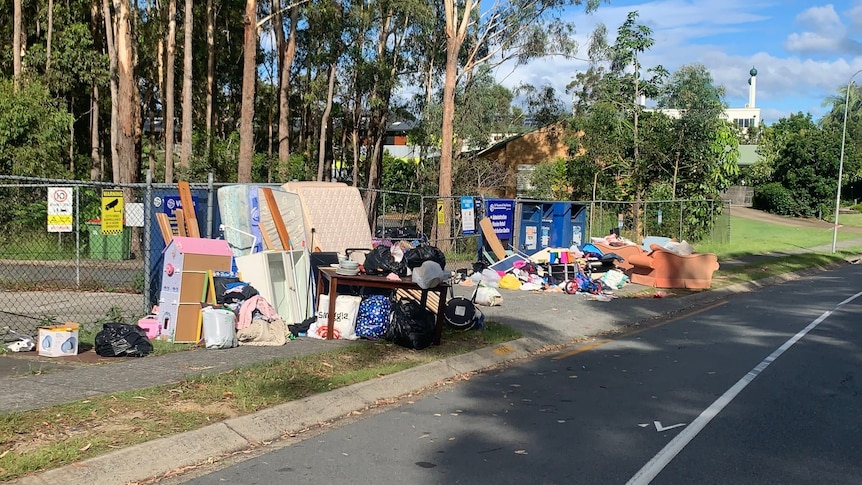 Dumped furniture and rubbish on footpath.