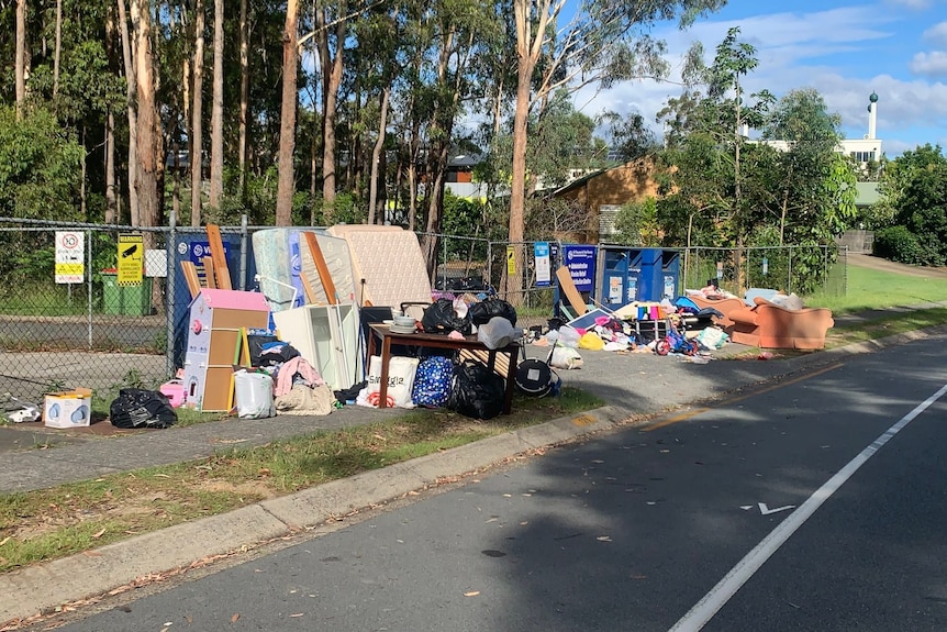 Dumped furniture and rubbish on footpath.