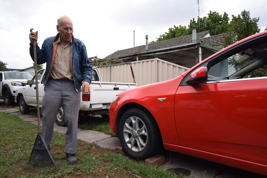 Robert Kelsall standing near his car.