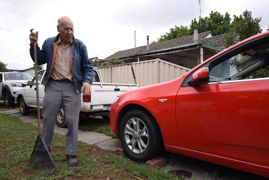 Robert Kelsall standing near his car.