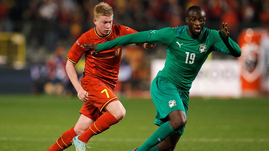 Belgium's Kevin De Bruyne (L) and Ivory Coast's Yaya Toure (R) battle for the ball in March 2014.