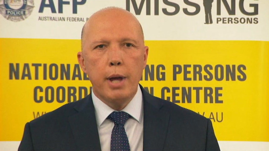 Peter Dutton speaks in front of a yellow and white background.