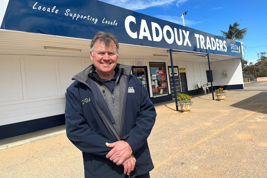 man in front of a store in Cadoux