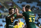 Two men celebrate a try in a rugby league test match