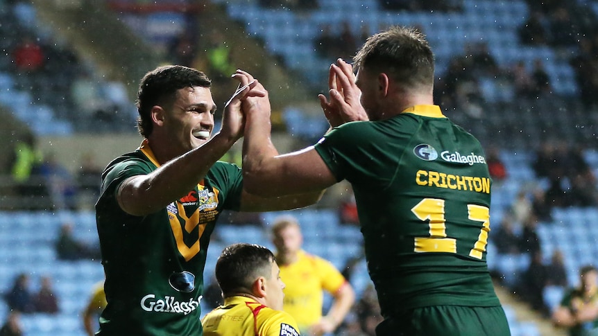 Two men celebrate a try in a rugby league test match