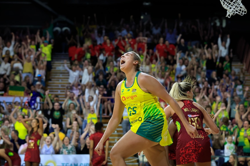 Donnell Wallam throws her head back and lets out a roar as members of the crowd stand of their seats cheering