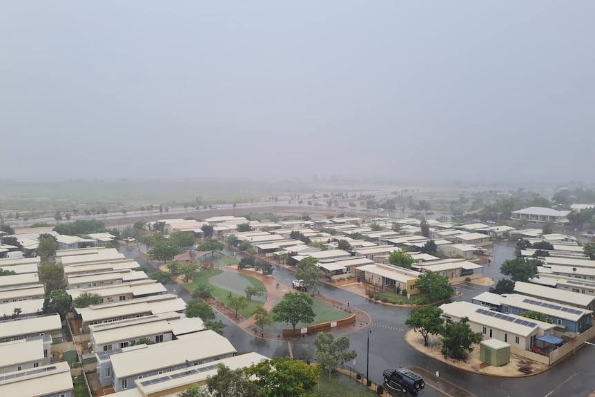 Low gray clouds linger over the houses.