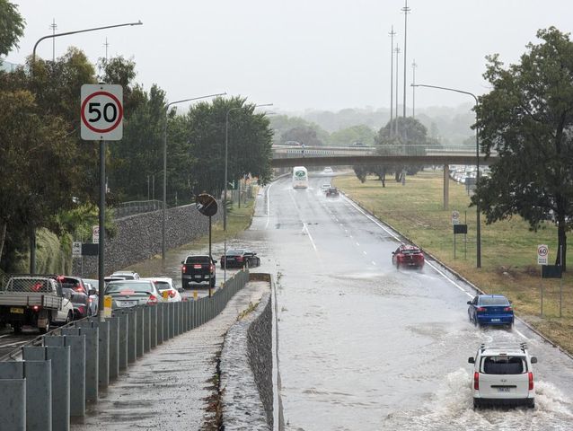 Cars driving through flooded Parkes Way
