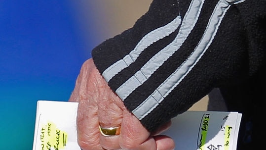 All Blacks coach Graham Henry holds his training notes during a session at Trinity Grammar School.