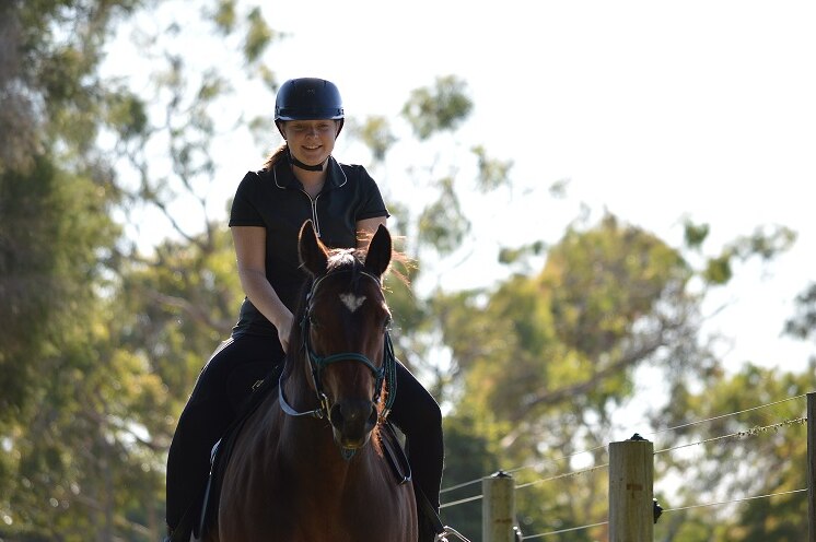 Natasha Johnson's daughter Sophie rides a horse.