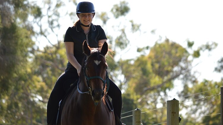 Natasha Johnson's daughter Sophie rides a horse.