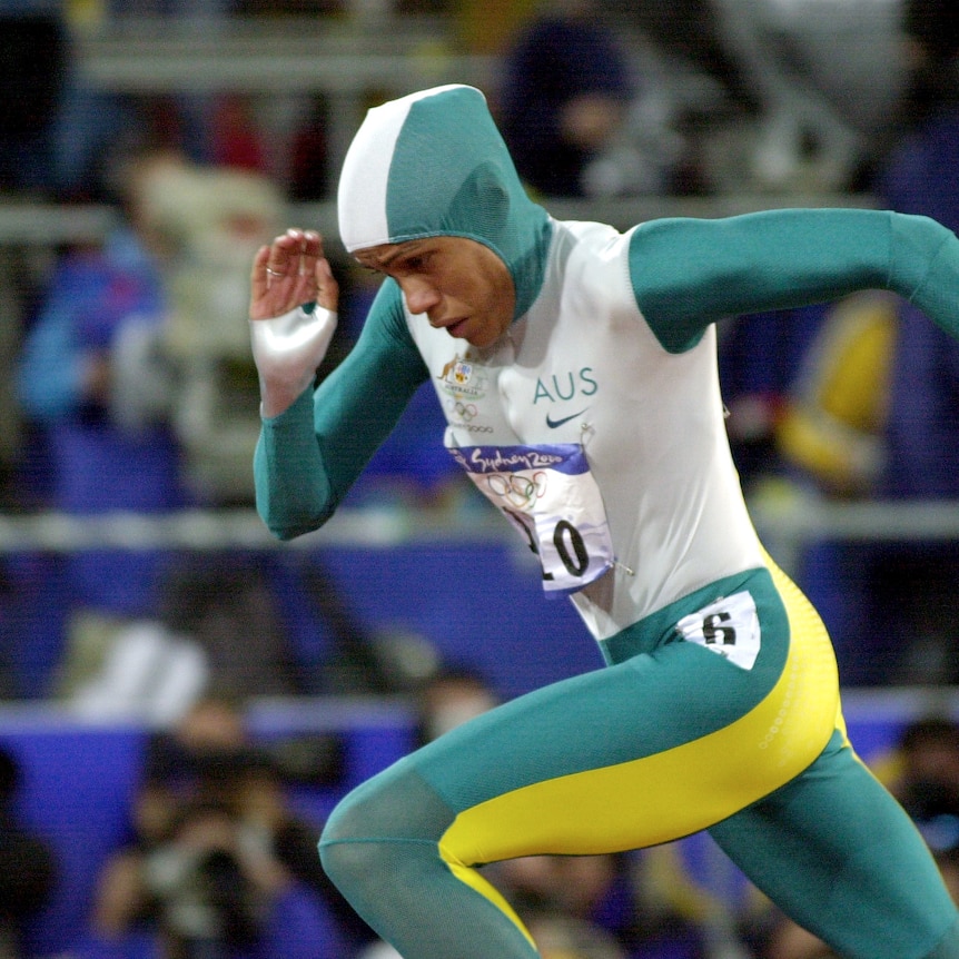 Australian Indigenous female runner Cathy Freeman, in stride, during her gold medal run at the Sydney Olympics
