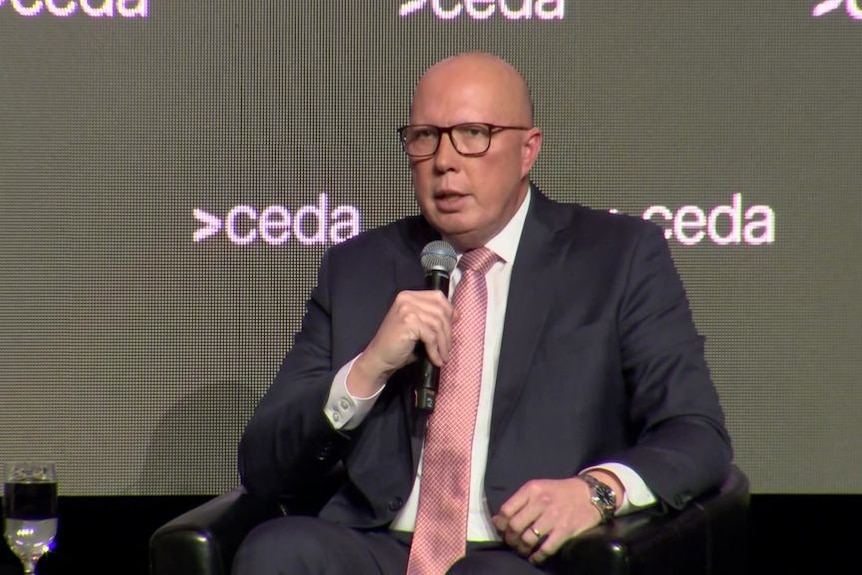 Peter Dutton speaking into a microphone while sitting on a stage. A backdrop has 'ceda' branding on it.