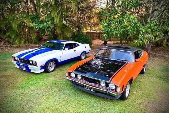 blue and white, and orange and black cars