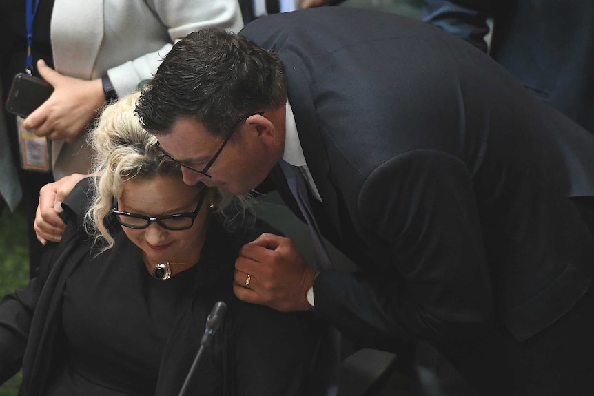 Victorian Premier Daniel Andrews embraces Health Minister Jill Hennessy in Victoria's Parliament.