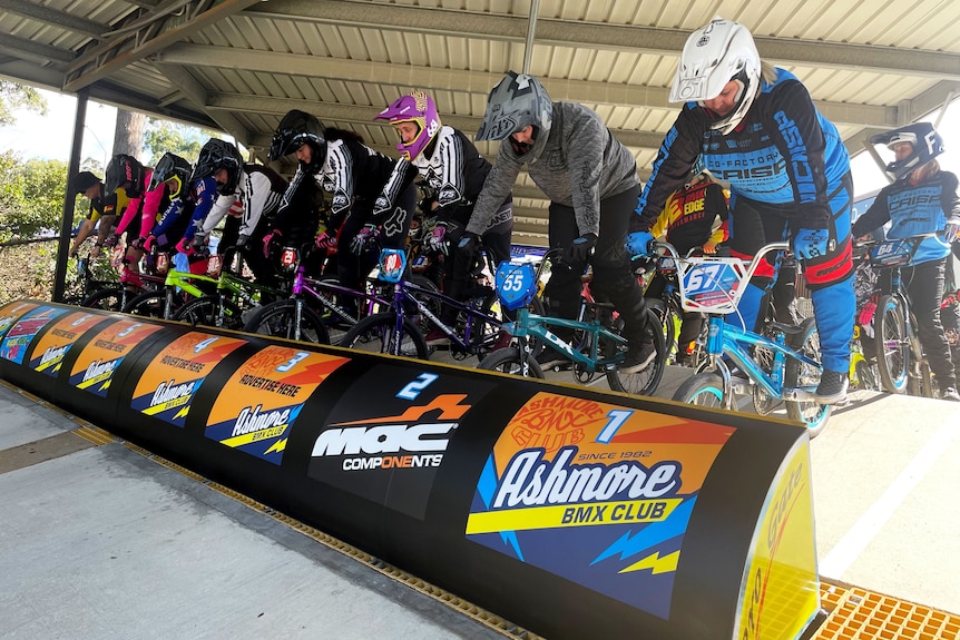 Female competitors line up at the gate at a BMX bike race meet on Queensland's Gold Coast.