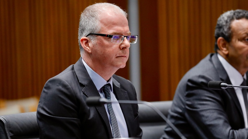 Matt Raos during the inquiry sitting in front of a little microphone. 