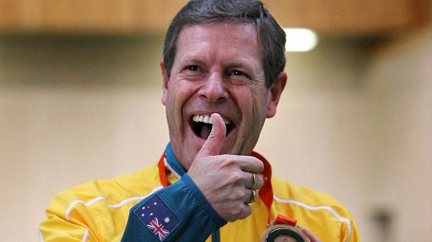 Warren Potent celebrates after receiving his bronze medal in the men's 50m rifle prone.