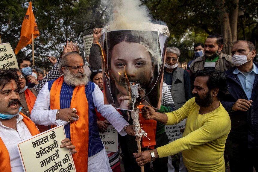 Activists from United Hindu Front burn an effigy depicting climate change activist Greta Thunberg.