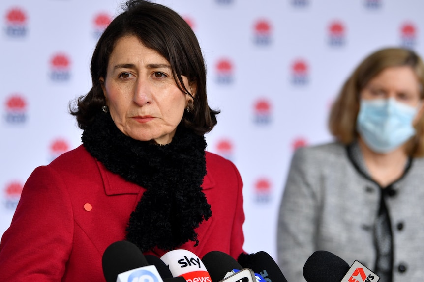 Gladys Berejiklian wearing a red coat and scarf