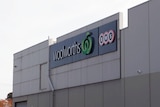An image showing the side of a commercial office building, with a Woolworths sign at Mooroopna