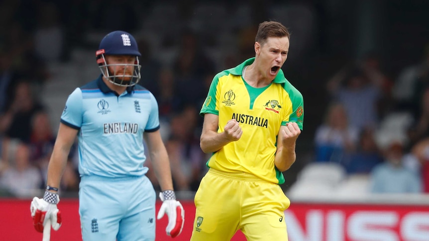 Australian bowler Jason Behrendorff pumps his fists in celebration as England batsman Jonny Bairstow looks on from behind.