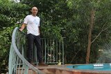 Entrepreneur Michael Bruvel standing next to his above-ground pool in an Aquasense t-shirt.