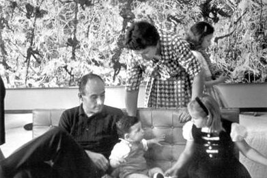 The Heller family sits in front of Blue Poles in their home.