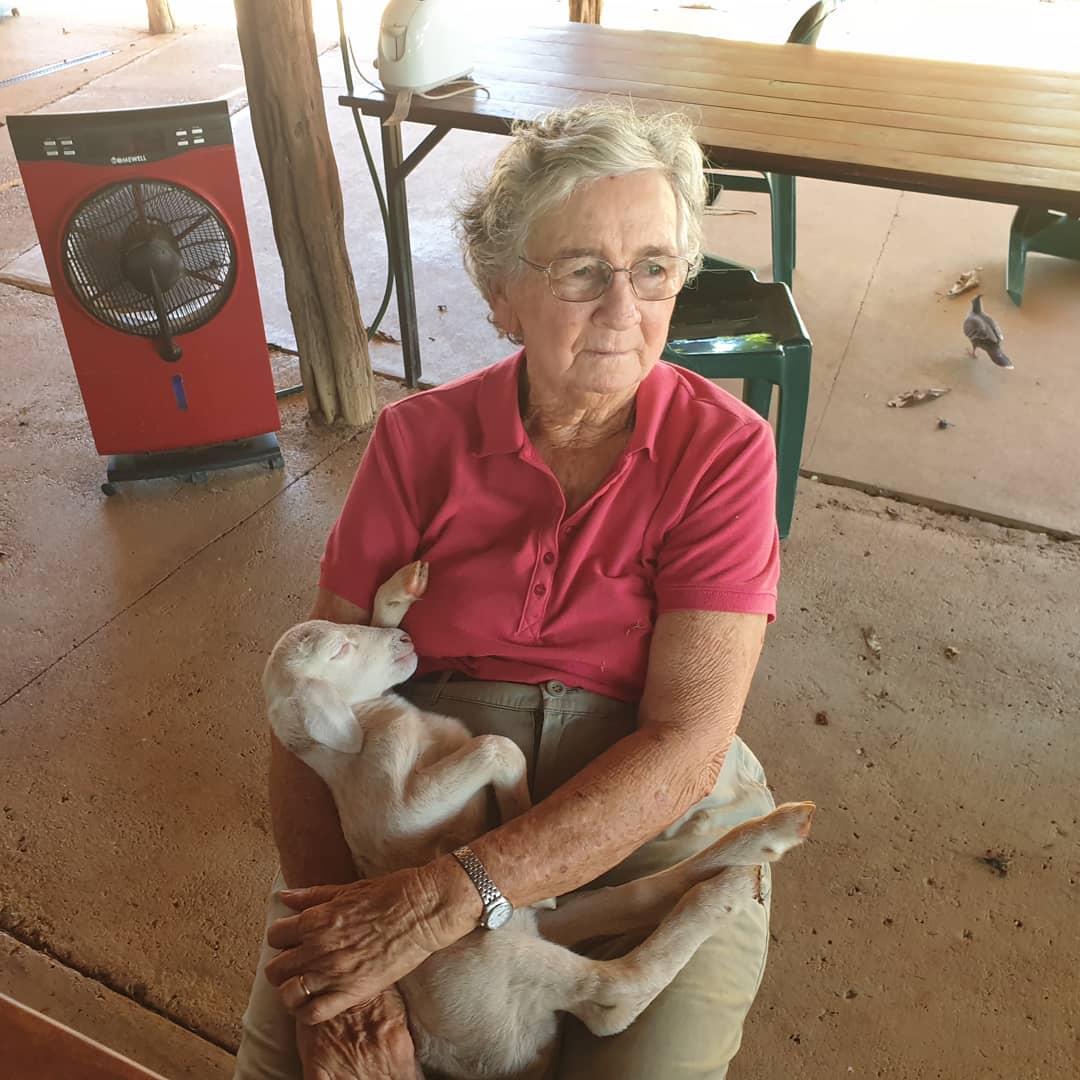 Old woman holding lamb