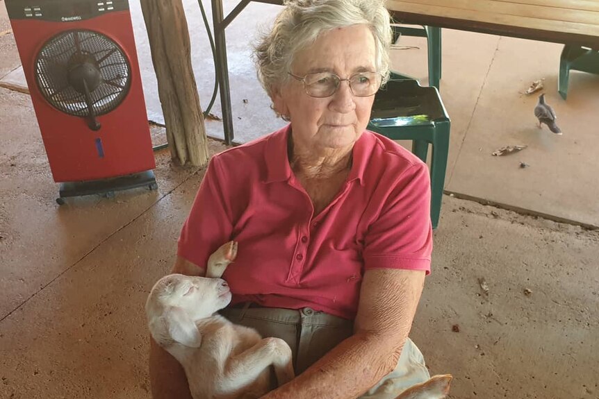 Old woman holding lamb
