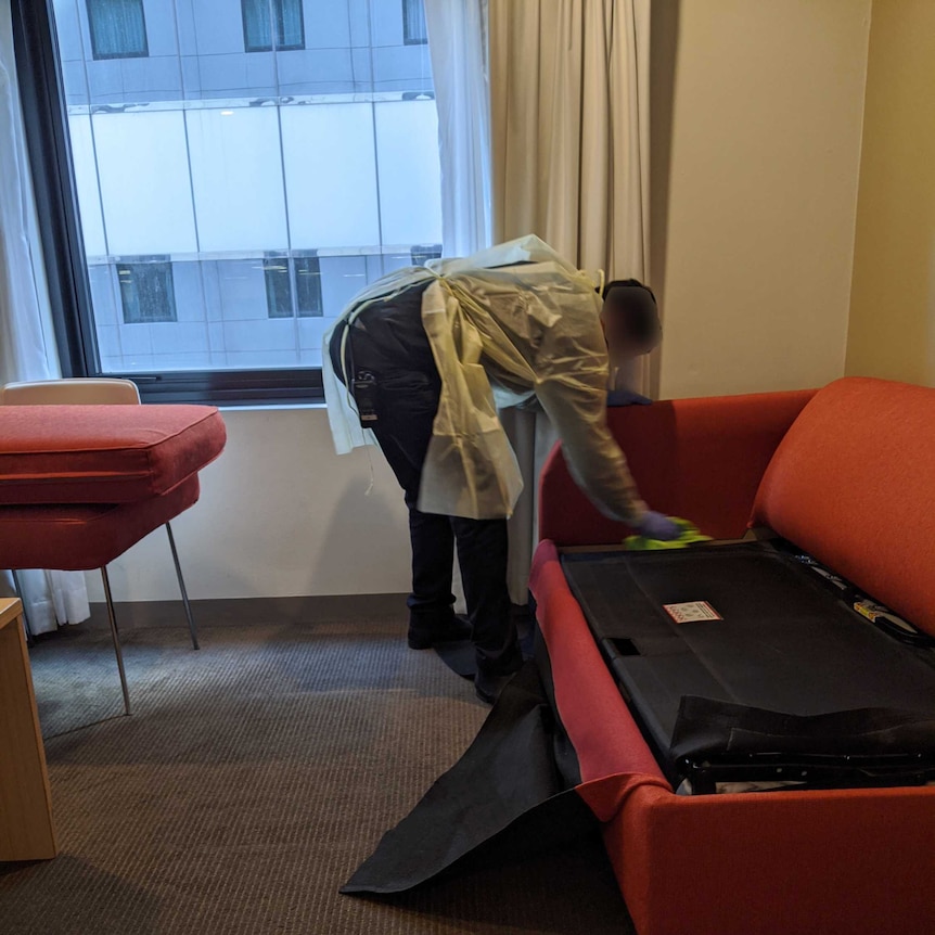 A cleaner in a hotel room