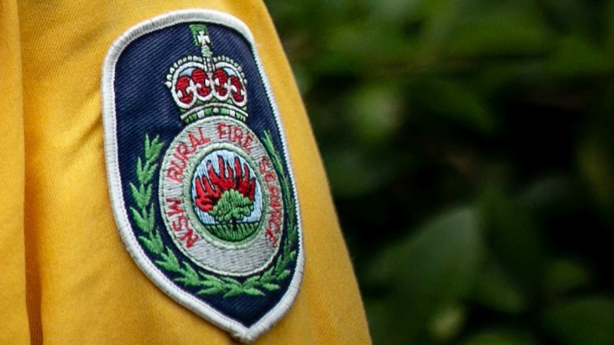 A cloth badge on the side of a uniform that says "NSW Rural Fire Service"