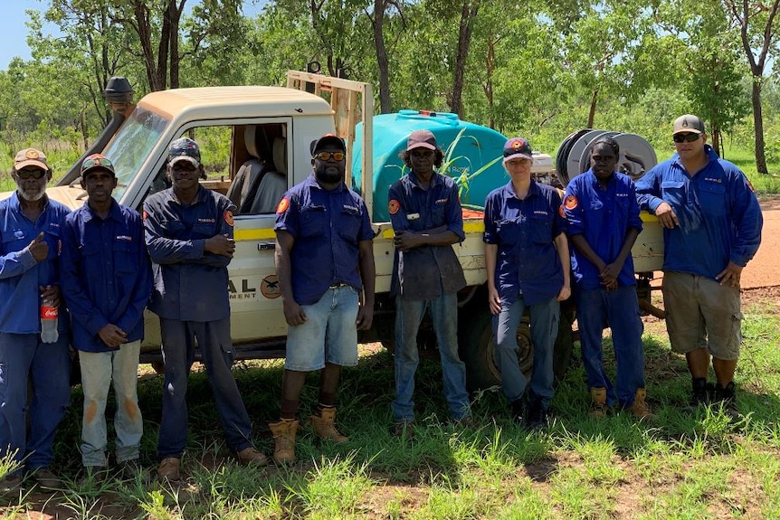 A group photo of the Mimal rangers next to a ute