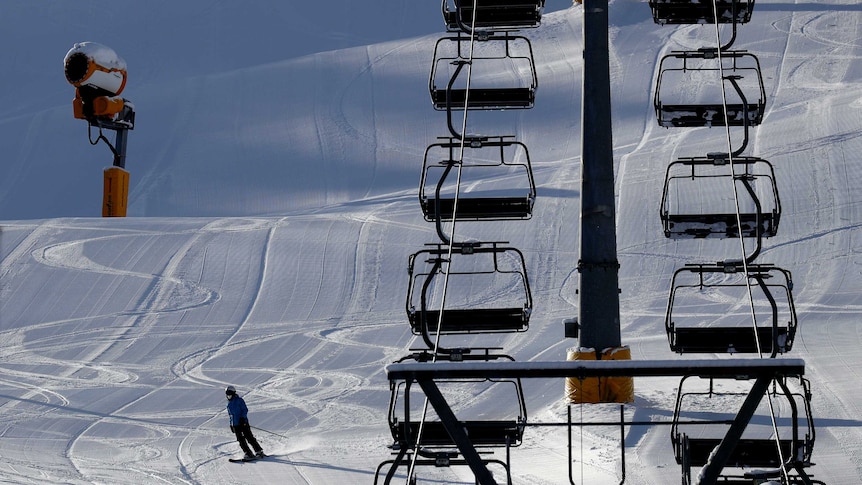 A skier speeds down the slope besides an empty chairlift in the Austrian province of Tyrol.