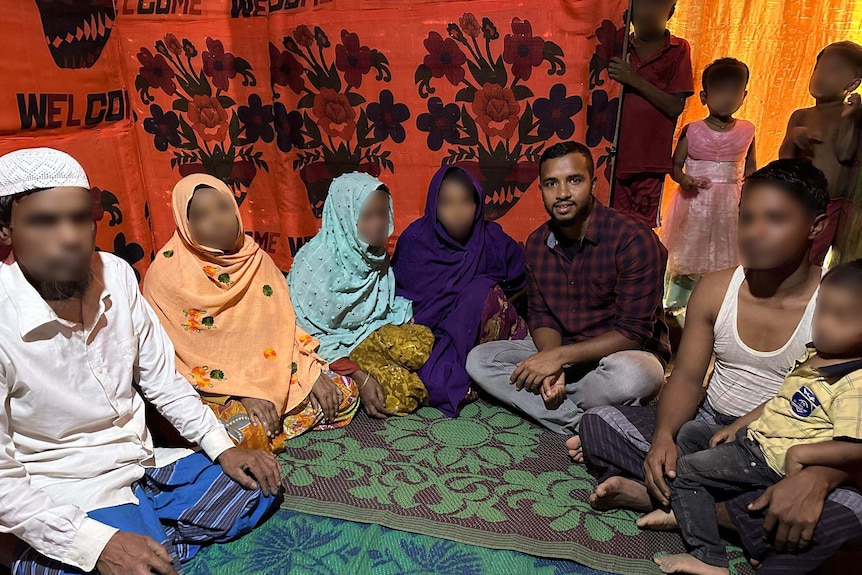 Samsul Alam with nine members of his family. Their faces are blurred. 