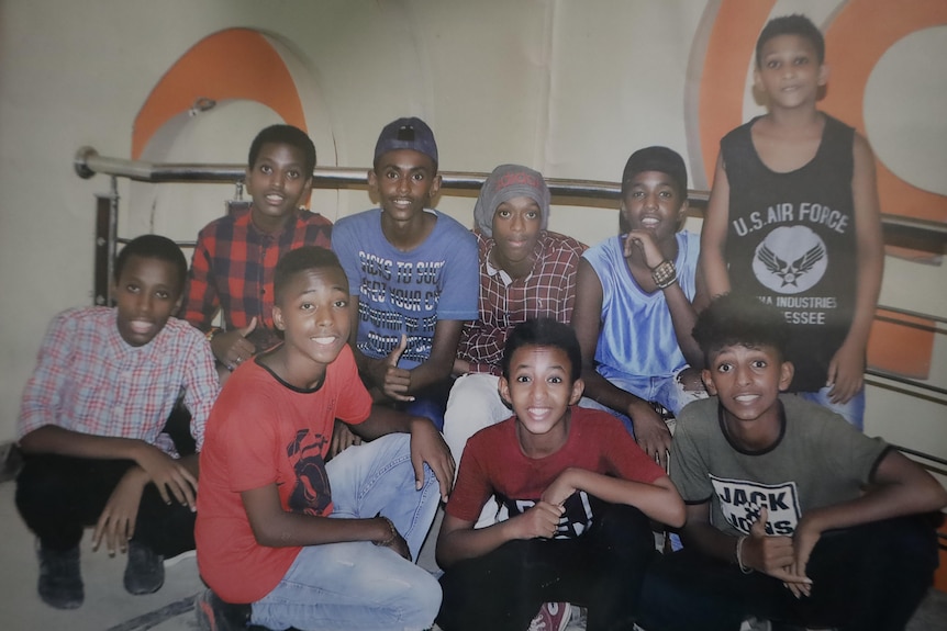 A group of boys smile at the camera