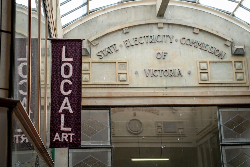 A fabric sign reading Local Art hangs in the atrium