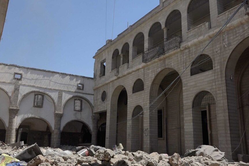 Debris and rubble litters the church courtyard