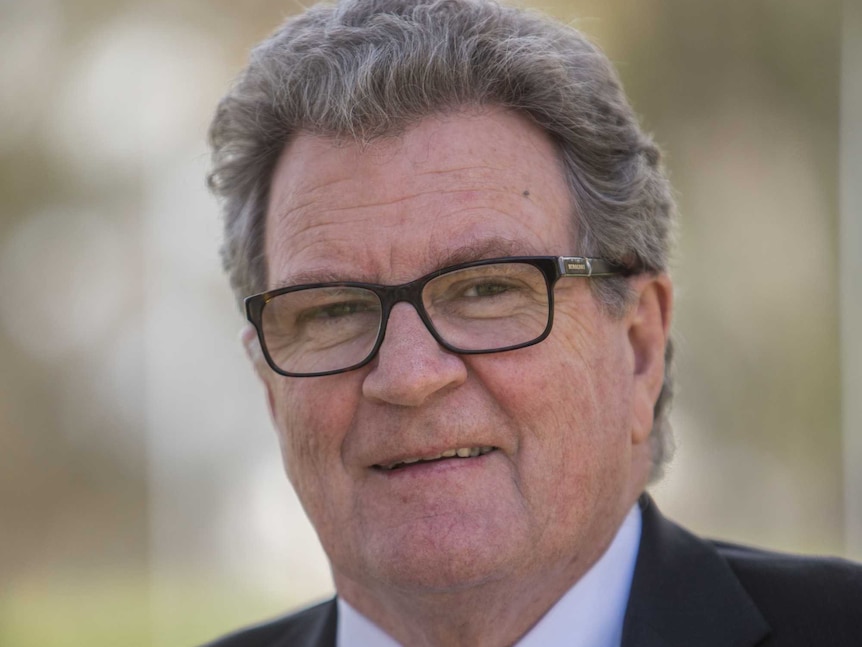 Portrait of Richard Vines, standing outside with a blurred background.