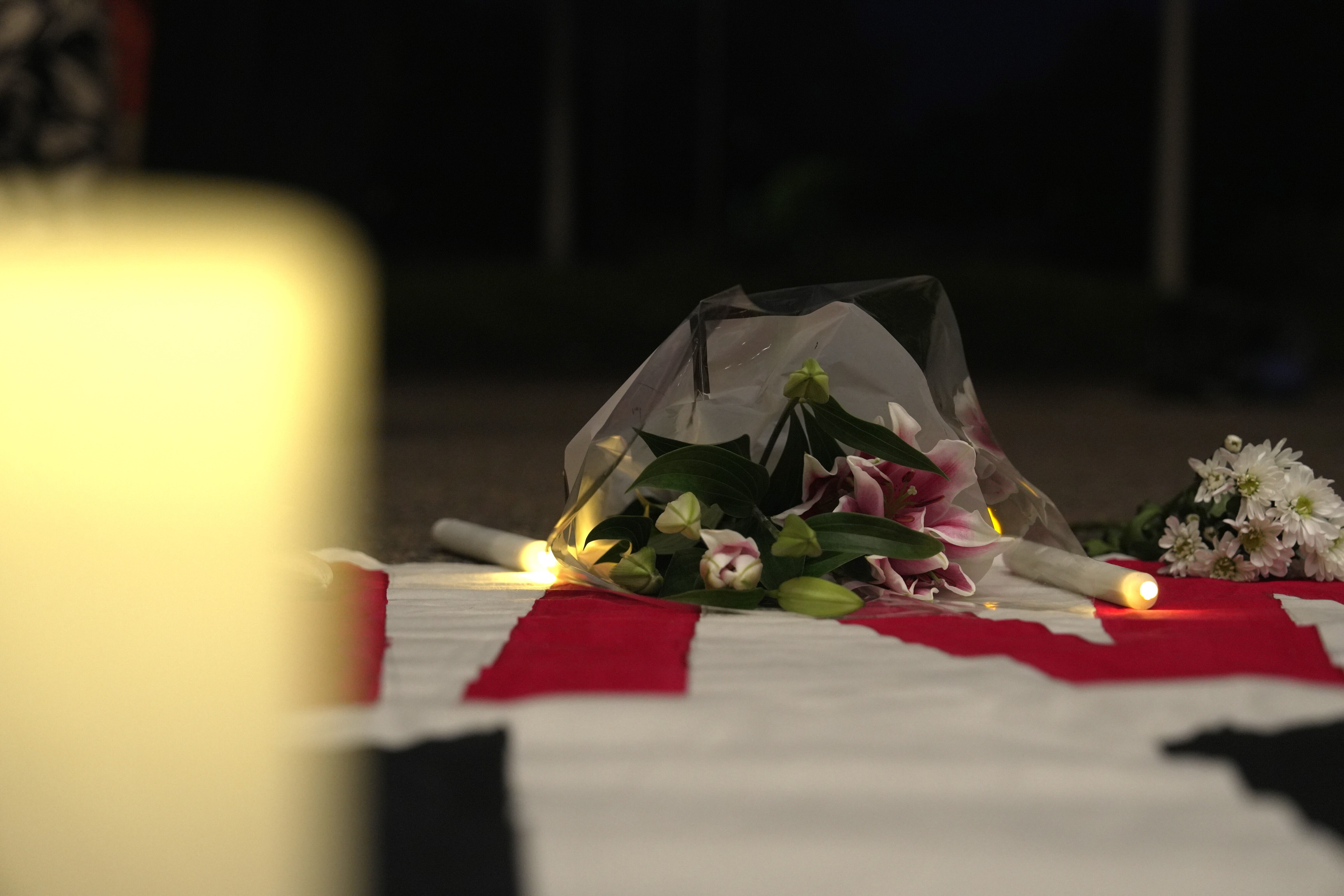 Candles And Flowers Laid In remembrance Of Kumanjayi White