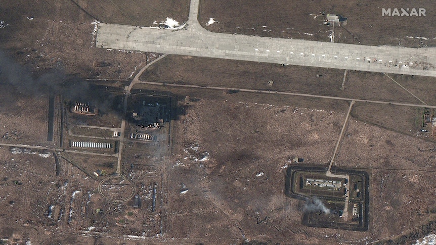 A plume of smoke arises from sites on the airfield