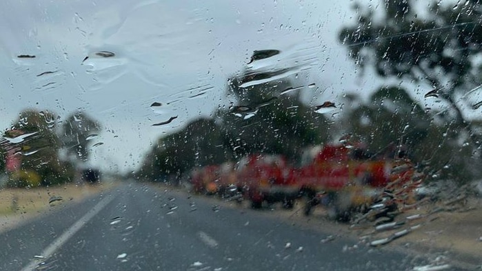 Rain on the lens fire trucks in the backdrop