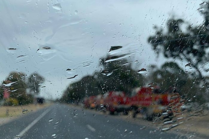 Rain on the lens fire trucks in the backdrop